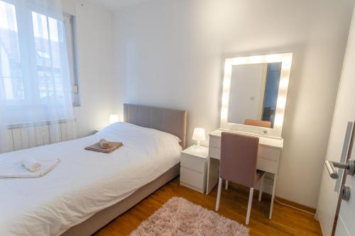 a bedroom with a bed and a desk and a mirror at ANAMARIE Apartment, free parking, Belgrade, Center, SRB in Vračar (historical)