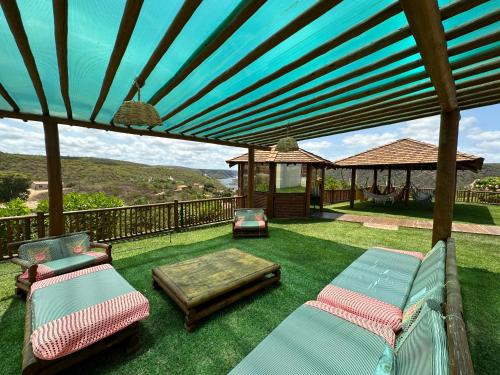 a patio with chairs and a gazebo at Hotel Aconchego do Velho Chico in Piranhas