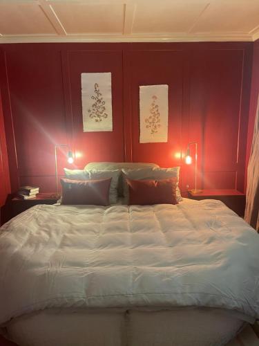 een slaapkamer met een groot bed met rode muren bij bed,Beet&breakfast „ds aute Pfarrhuus“ in Rapperswil