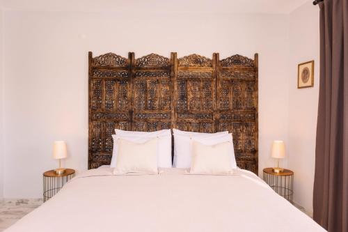 a bedroom with a large bed with a wooden headboard at Dia Urla in Urla