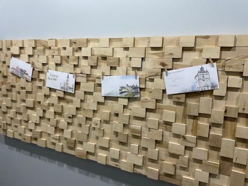 a wall of cardboard boxes with pictures on it at «ГОРИ́ЩЕ на площі Польський ринок» in Kamianets-Podilskyi