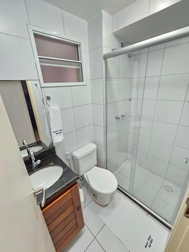 a bathroom with a shower and a toilet and a sink at Apartamento Beach Village Praia do Futuro by WL Temporada in Fortaleza