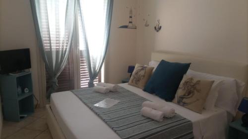 a white couch with pillows on it in a room at B&B fragranza di sicilia in Giardini Naxos