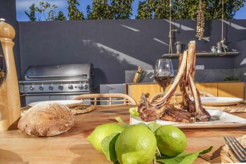 a table with a plate of food and a glass of wine at Villa Capparis in Moírai