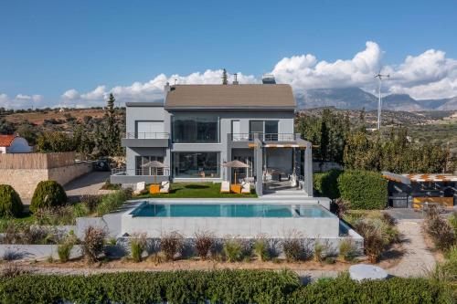 an aerial view of a house with a swimming pool at Villa Capparis in Moírai