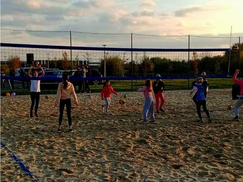a group of people playing soccer on a field at Landena Apartments Lendava in Lendava