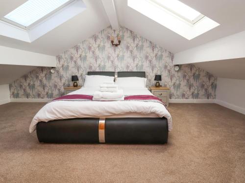 a bedroom with a large bed in a attic at The Parlour in Frodsham