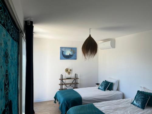 2 camas en una habitación con paredes blancas en Villa Héliopolis, en Ventiseri