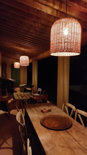 a dining room with a table with chairs and lights at Emplacement idéal dans le Var ! in Cuers