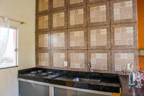 a kitchen with a sink and a counter top at Casa Da Cléo Carrancas in Carrancas
