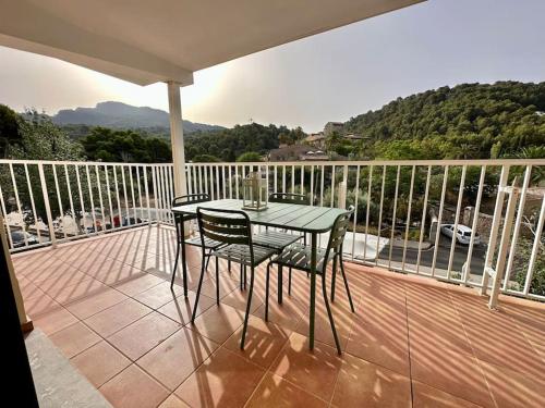 a table and chairs on a balcony with a view at Apartamento Moderno con gran terraza" GREGAL" in Port de Soller