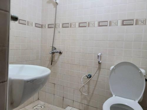 a small bathroom with a toilet and a shower at NICE APARTMENT in Kituoni