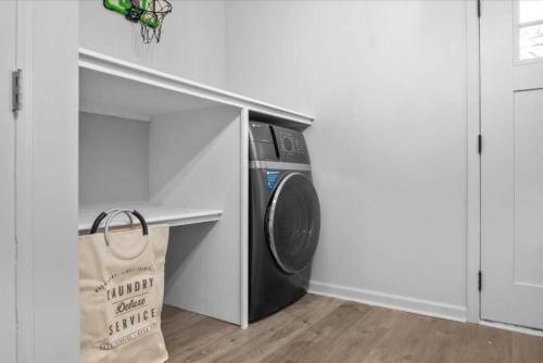 a washer and dryer in a corner of a room at Near River St, Forsyth & DT - Stylish - Free Parking in Savannah