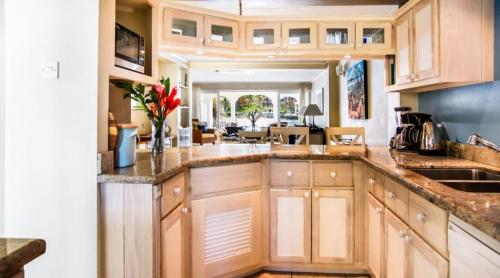 a kitchen with wooden cabinets and a counter top at Waterfront townhouse - Harbour 17 townhouse in Gros Islet