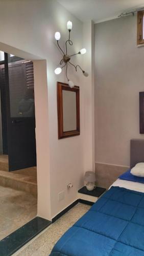 a bedroom with a blue bed and a mirror at Gi&Sa in Gallipoli