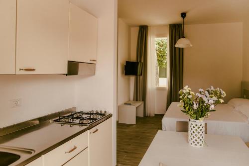 a small kitchen and living room with a bed at Residence Altair - Serra degli Alimini in Otranto