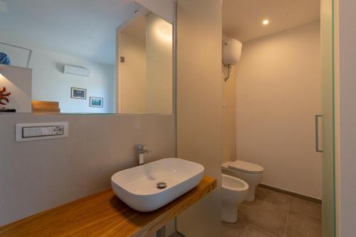a bathroom with a sink and a toilet at Residence Agape in Cefalù