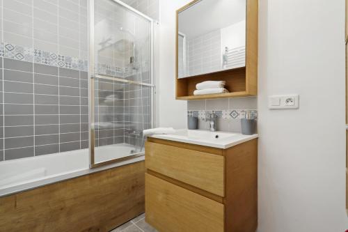 y baño con lavabo y ducha. en Large family T3 with parking near La Défense, en Nanterre