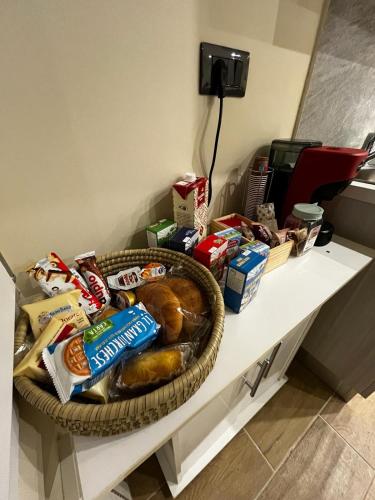 a table with a basket of bread and other food on it at PARADISO HOME in Augusta