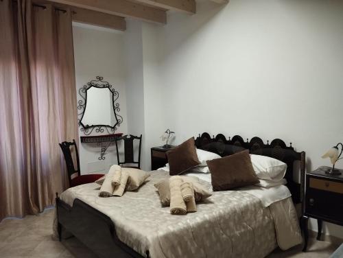 a bedroom with a large bed with pillows on it at Affittacamere Vicino al Porto in Porto Torres