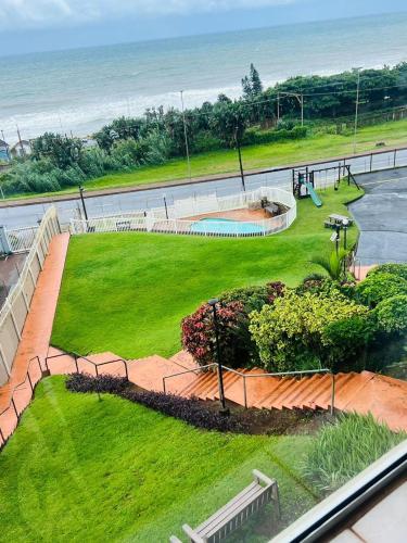a view of a park with a swimming pool and the ocean at Beach View in Scottburgh