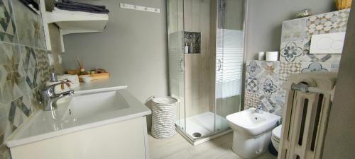 a small bathroom with a sink and a toilet at Ca' Balenga - Cozy Stay in the Old Town with Free Private Parking in Asti