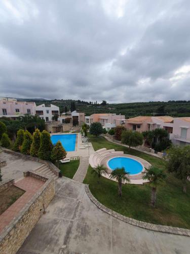 an aerial view of two swimming pools in a suburb at Urania Luxury Suite with pool view -Loutra Resort in Loutra
