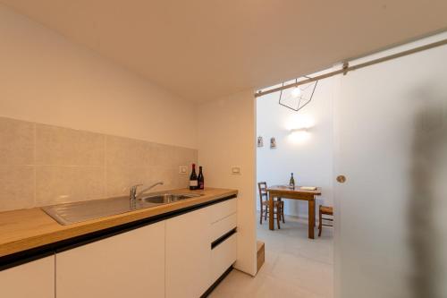 a kitchen with a sink and a dining room at Residence Agape in Cefalù