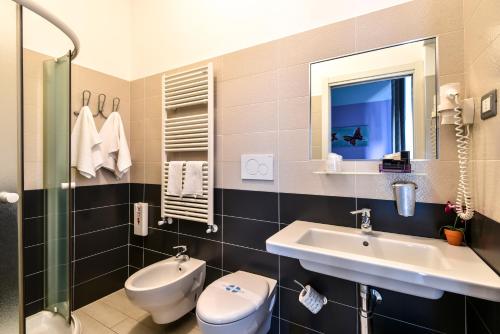 a bathroom with a sink and a toilet and a mirror at Villa Bianca Hotel & Spa in San Salvo