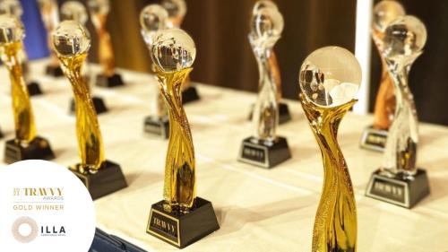 a row of awards on a table with a table cloth at Illa Experience Hotel in Quito