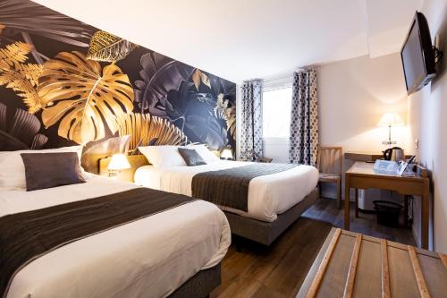 a hotel room with two beds and a flat screen tv at Logis Hôtel la Grassinais Saint-Malo in Saint Malo