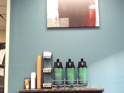 a shelf with four hair products on a wall at Quality Inn & Suites Wilsonville in Wilsonville