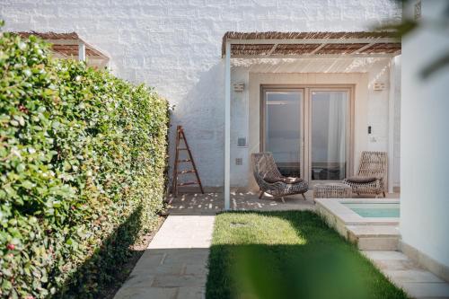 a garden with a ladder next to a house at Masseria Longa Boutique Hotel in Otranto