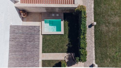 a dog laying on the grass next to a building at Masseria Longa Boutique Hotel in Otranto