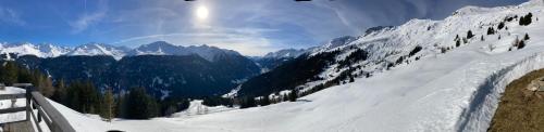 a snow covered mountain with the sun in the sky at Haus Ladner in See