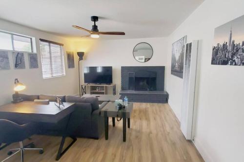 a living room with a couch and a fireplace at Spacious 1 bedroom less than 1 mile to Beach & DT in Huntington Beach