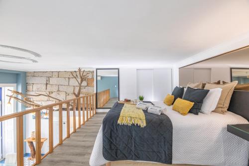 a bedroom with a large bed and a staircase at Deluxe Spacious Flats w Mezzanine by Host Wise in Porto