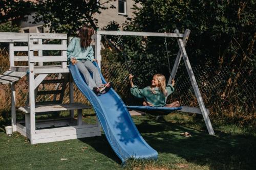 two young girls playing on a slide at Kosowisko in Miłki