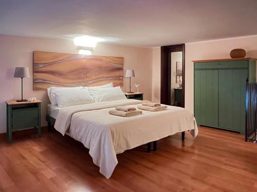 a bedroom with a large bed with towels on it at Etna Home in Catania