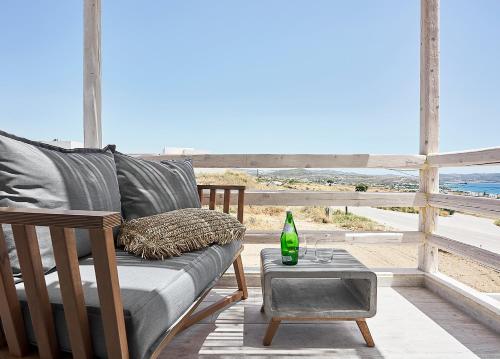 a couch on a porch with a view of the beach at Nirome Luxury Suites in Adamas