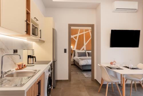 a kitchen with a sink and a table in a room at DK APARTMENTS in Ioannina