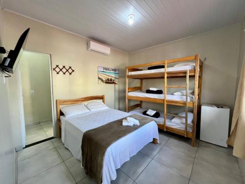 a bedroom with a bed and a bunk bed at CASA BRANCA - Jijoca de Jericoacoara in Jijoca de Jericoacoara