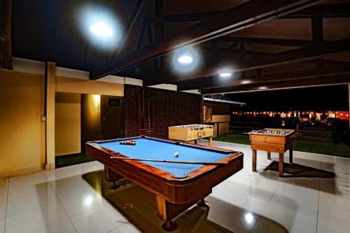 a pool table in a room with a view of the city at Hotel Villa Florencia in Turrialba