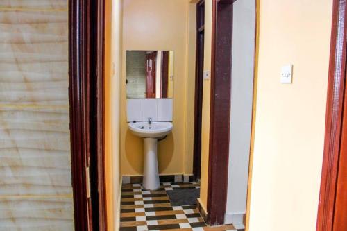 a bathroom with a toilet and a sink at Eagles one bedroom in Kisii CBD with Balcony in Kisii