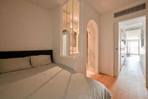 a bedroom with a bed and a hallway at Terrasse au coeur du Marais in Paris