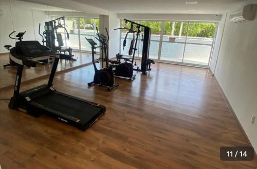 a gym with several treadmills and exercise bikes at Flat em Boa Viagem in Recife