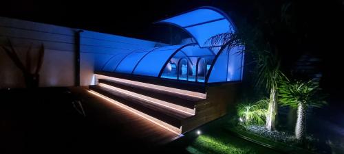a house with blue lights on the stairs at night at La Maison della Valle in Agrigento