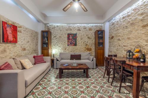 a living room with a couch and a table at Malama's maisonette at the historic center in Heraklio Town
