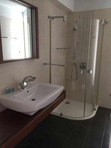 a bathroom with a sink and a shower at Luxurious Family friendly Villa Anavyssos in Anavissos