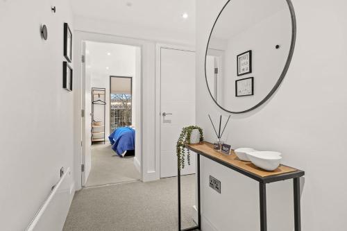 a bathroom with a sink and a mirror on the wall at Atlas House Three in Harrogate